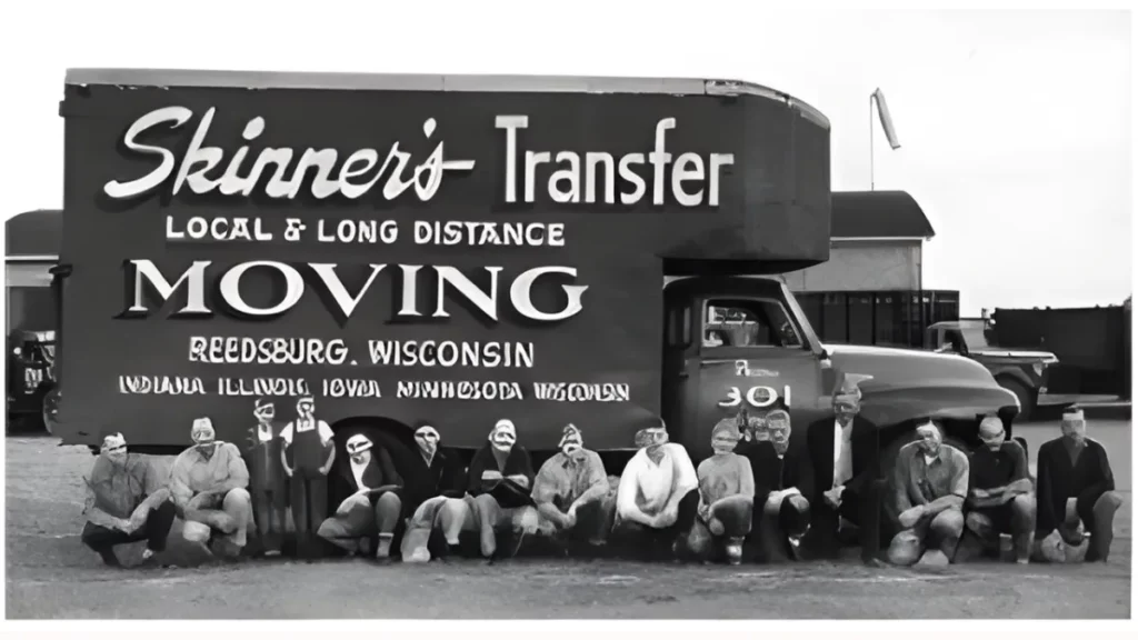 Workers pose in front of a vintage moving truck with "Skinner's Transfer" signage, highlighting the company's local and long-distance services in Reedsburg, Wisconsin.
